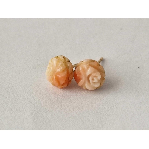 542 - A pair of coral ear studs and another 9ct