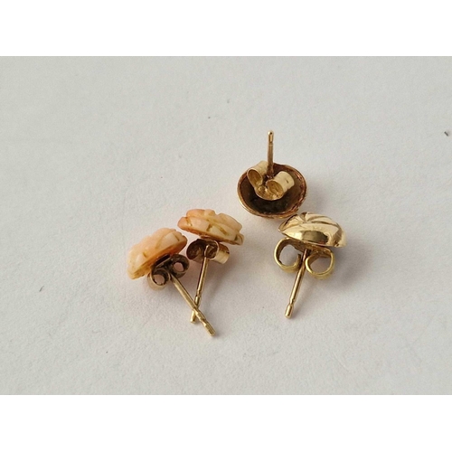 542 - A pair of coral ear studs and another 9ct