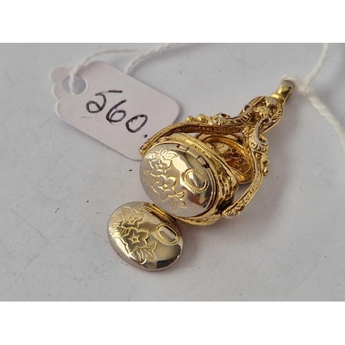 560 - A gilt triple spinning fob with opening lockets