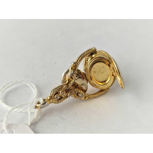 560 - A gilt triple spinning fob with opening lockets