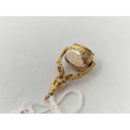 560 - A gilt triple spinning fob with opening lockets