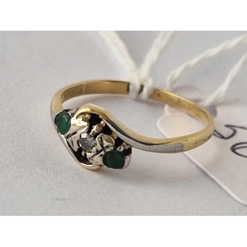 569 - A emerald and diamond three stone cross over ring 18ct gold  2 gms