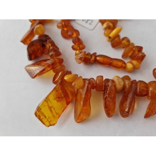 582 - A string of rough amber beads