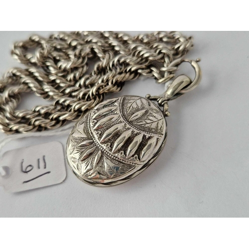 611 - Victorian silver oval embossed locket, suspended from a rope link silver collar  �80