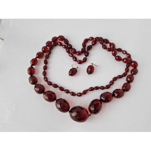 87 - A String Of Faceted Red Bead Necklace And Earrings