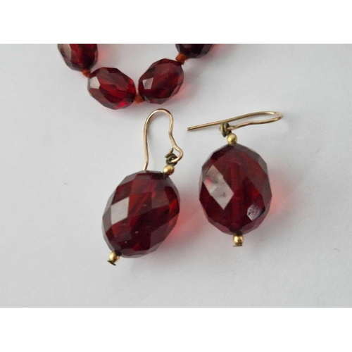 87 - A String Of Faceted Red Bead Necklace And Earrings