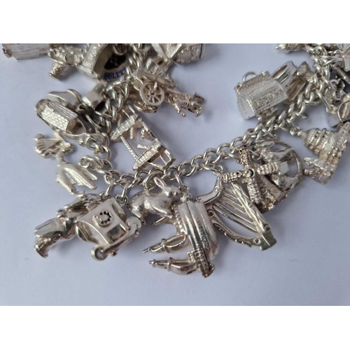 61 - A Heavy Vintage Silver Charm Bracelet 104G With Multiple Silver Charms