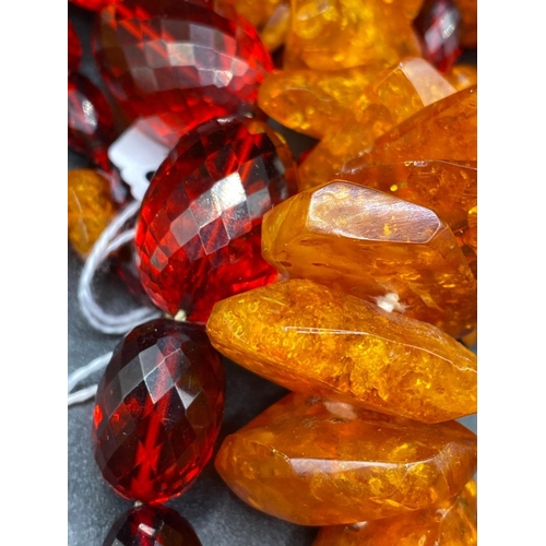 411 - A String Of Faceted Cherry Amber Beads 34 Inch And Rough Baltic Amber 28 Inch