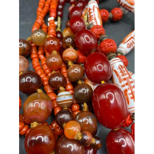 412 - A Quantity Of Coral Amber Style And China Necklaces