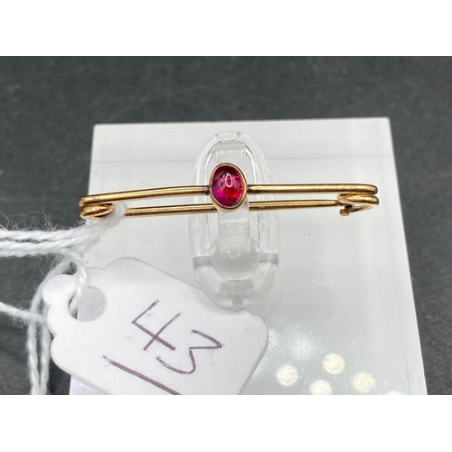 43 - A Miniature Burma Cabochon Ruby Pin