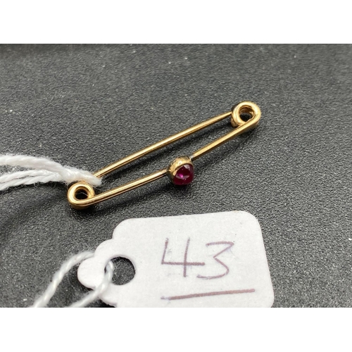 43 - A Miniature Burma Cabochon Ruby Pin