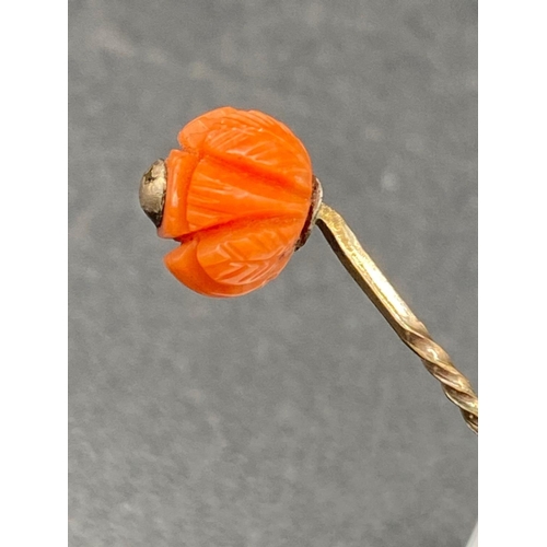 44 - A Coral Topped Stick Pin in the form of a Lotus Flower