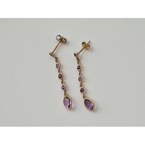 640 - A Pair Of Amethyst Dangly Ear Pendants 9Ct