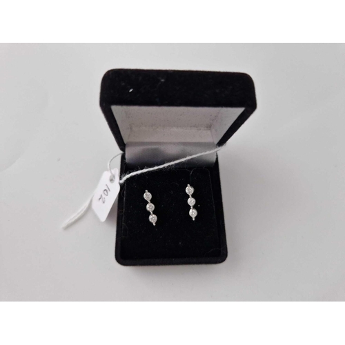 102 - A pair of three stone diamond earrings 9ct 1.5 cm drop boxed