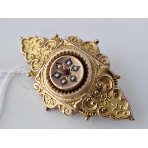 135 - A Victorian mourning brooch with ruby and pearls 15ct gold 7.6 gms