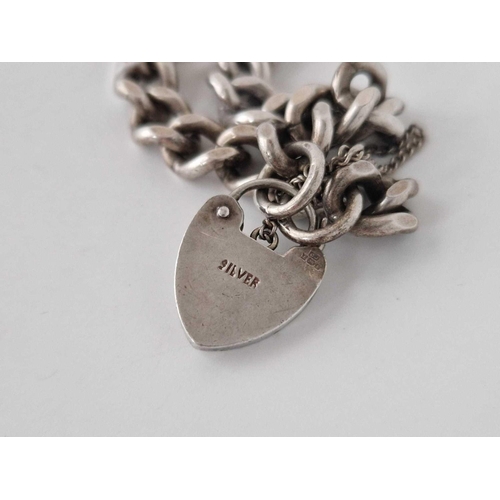 142 - A silver curb link bracelet with heart padlock, 29 g