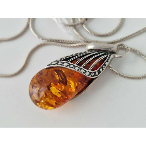 174 - A silver Baltic amber pendant on chain 15 inch