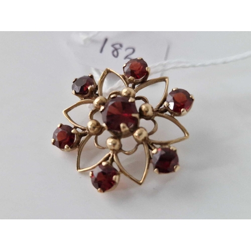 182 - A circular brooch with garnets 9ct 4.4 gms