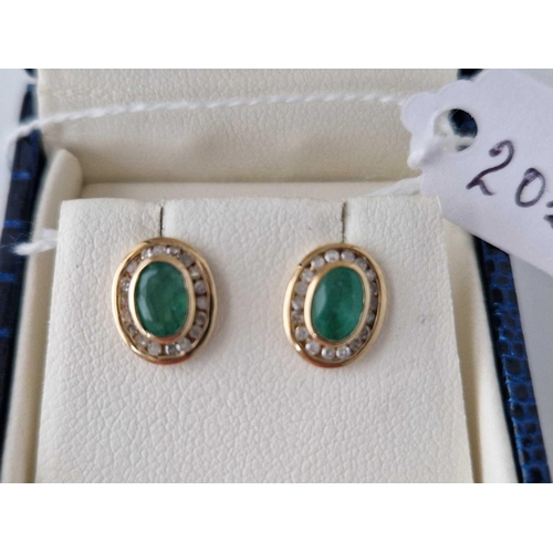 203 - A pair of emerald and diamond channel set earrings 9ct boxed