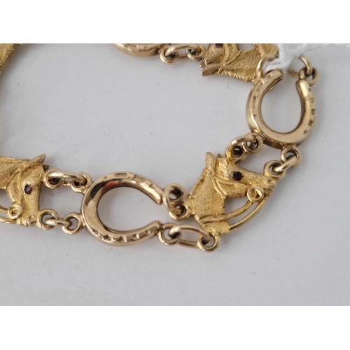 275 - A HORSESHOE HORSE HEAD 9CT BRACELET WITH GEM SET EYES 17.6g