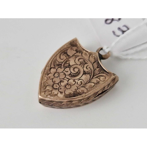 283 - A gold back and front shield shaped locket 2.5 gms