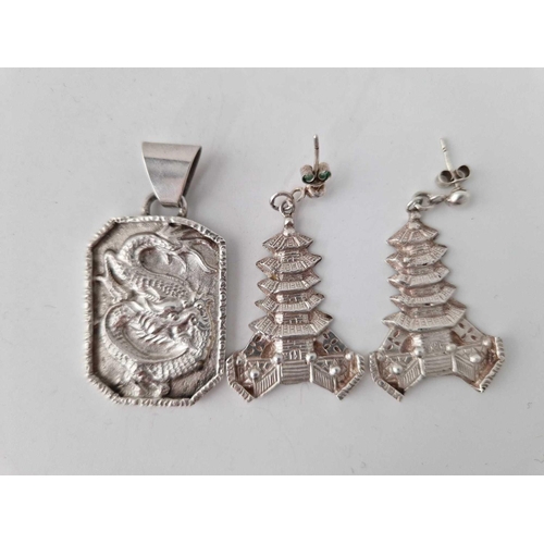 309 - A silver Chinese dragon pendant together with silver Chinese pagoda earrings 30 gms