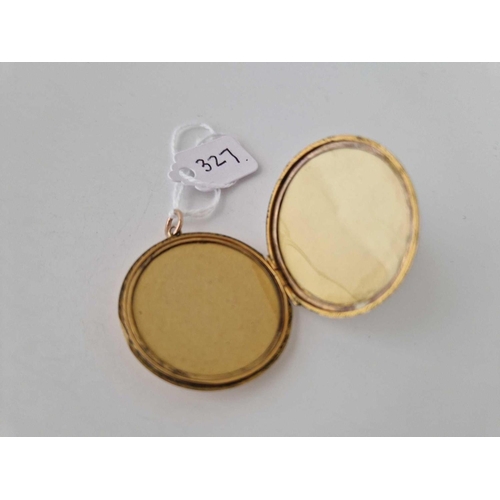 327 - A Victorian circular back and front locket with chased decoration to both sides 9ct 34 mm diameter