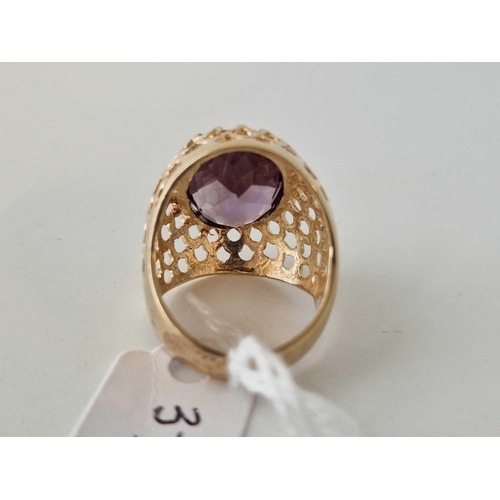 373 - A amethyst set pierced design bombe ring 9ct size M