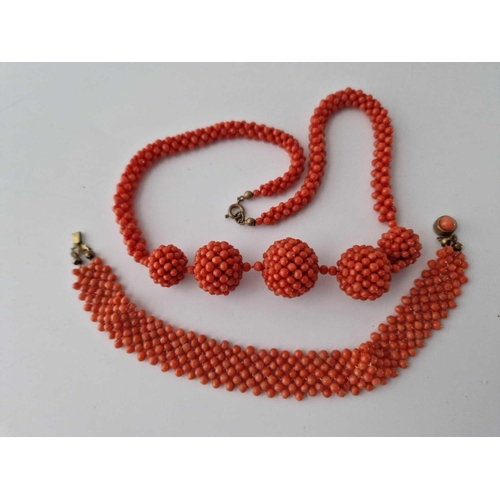 392 - A bag containing coral necklace, bracelet and a pair of earrings