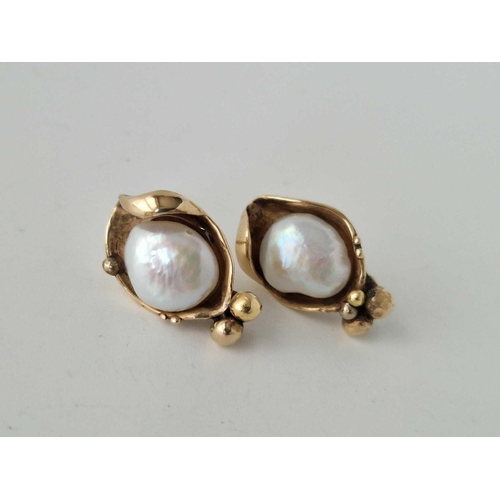 438 - A pair of blister pearl ear studs 9ct 7.7 gms