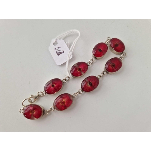 503 - A silver bracelet with flowers encapsulated in the red stones 7 inch