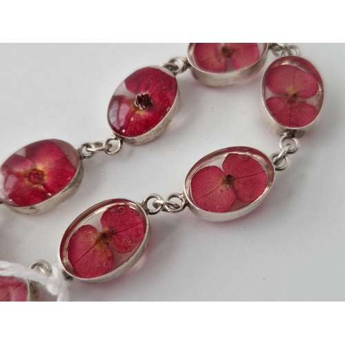 503 - A silver bracelet with flowers encapsulated in the red stones 7 inch