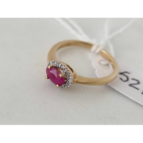 521 - A ruby and diamond cluster ring 9ct size M