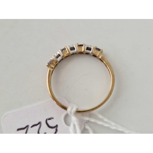 522 - A diamond and tanzernite seven stone half hoop ring 9ct size N