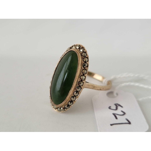 527 - A oval ring set with a green agate surrounded by marcasites 9ct size N