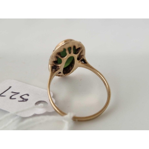 527 - A oval ring set with a green agate surrounded by marcasites 9ct size N