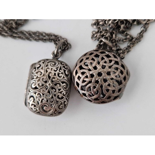 546 - Two pierced silver lockets on silver chains, 32 g