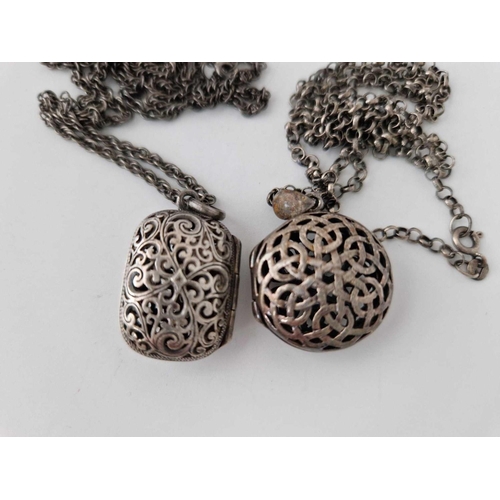 546 - Two pierced silver lockets on silver chains, 32 g