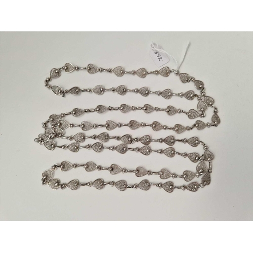 592 - A long silver filigree neck chain,  58 inch, 34 g