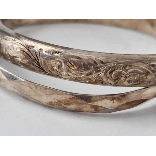 599 - Two hinged silver bangles, 37 g