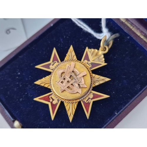 6 - A gold and enamel fob in the form of a cross, 9ct in a box. 9.9 g