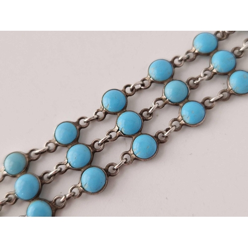 603 - A silver bracelet set with three rows of turquoise 6.5 inches