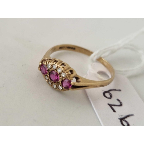 626 - A diamond and ruby boat shaped ring 9ct size N