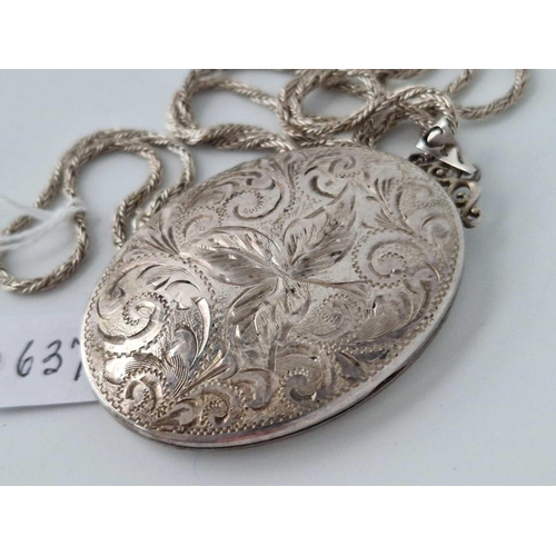 637 - A large silver locket on silver chain, 24.5 inch, 31 g.