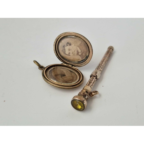 651 - A gold back and front locket and toothpick