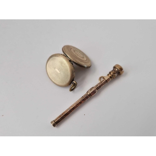 651 - A gold back and front locket and toothpick