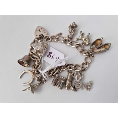 658 - A silver charm bracelet, 39 g.