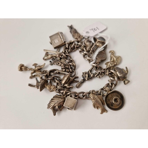 701 - A silver charm bracelet, 62 g