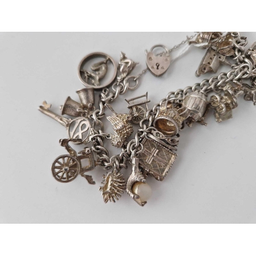 71 - A heavy silver charm bracelet 85g