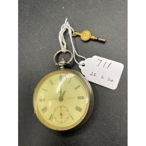 711 - A silver pocket watch with key and seconds dial